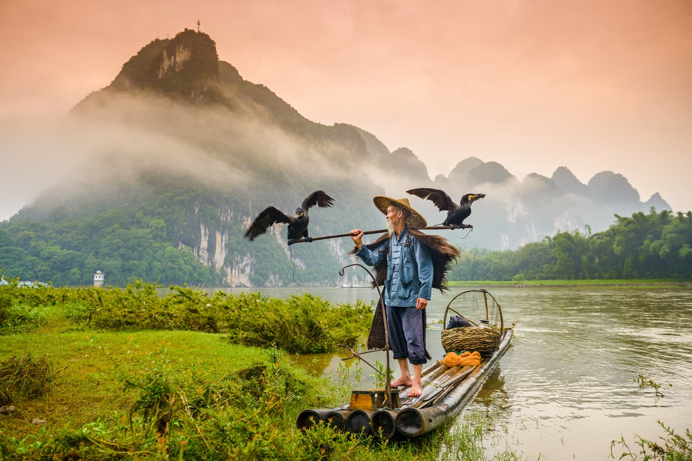 Fisherman works on the river near Yangshuo, China.