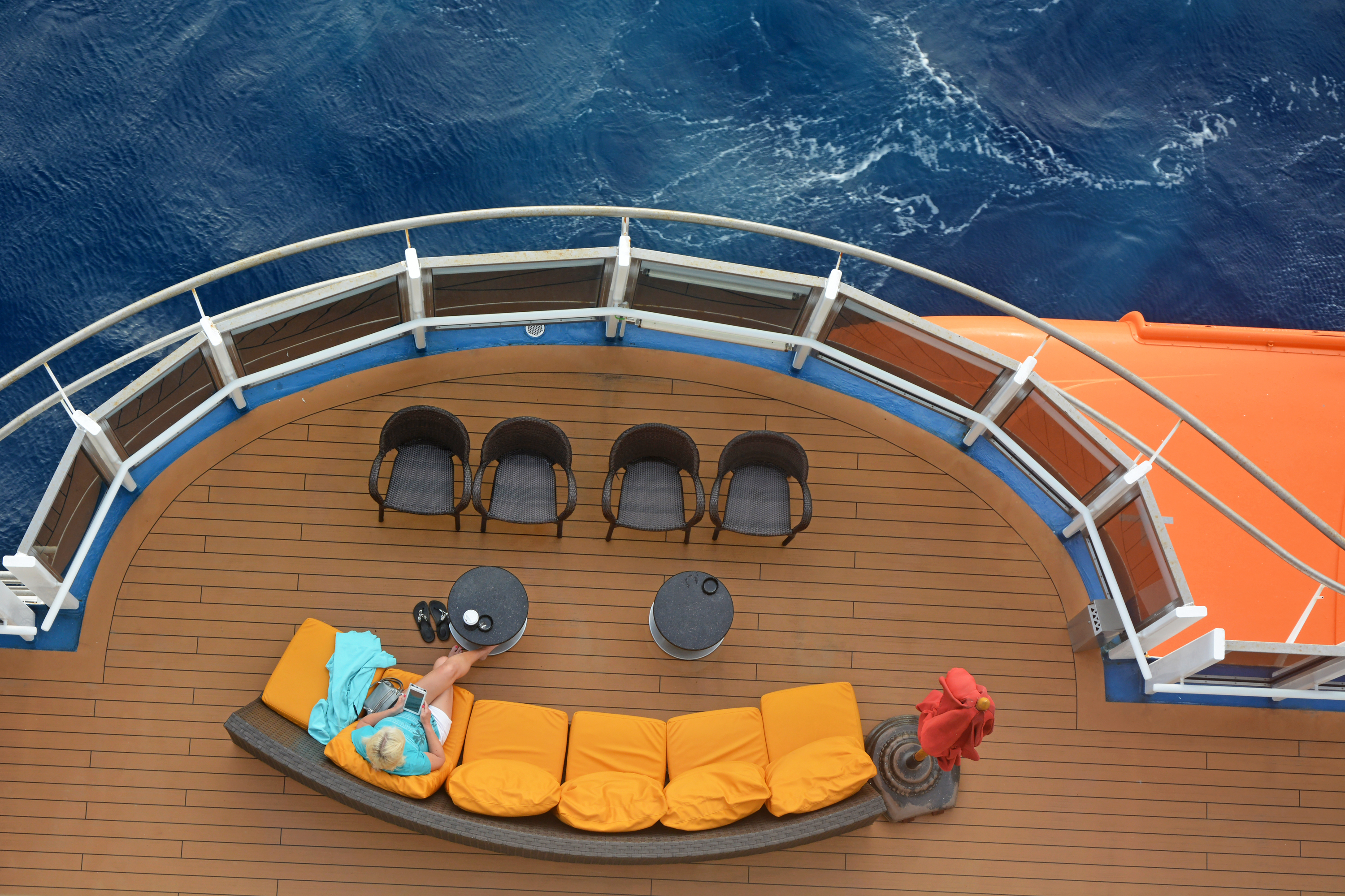 Woman reading her tablet at sea