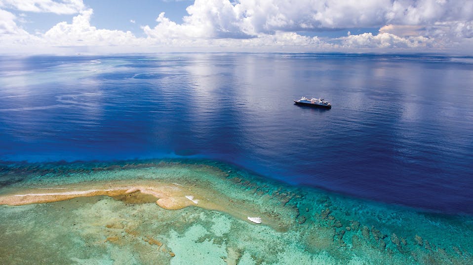 Silversea Silver Discoverer near a reef