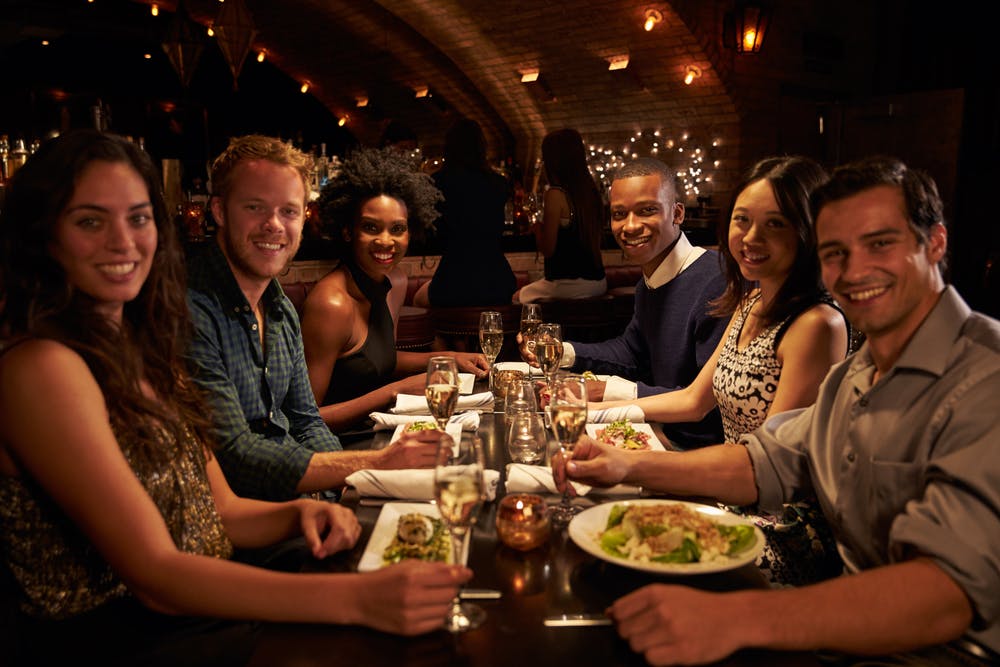 group enjoying wine and a gourmet meal